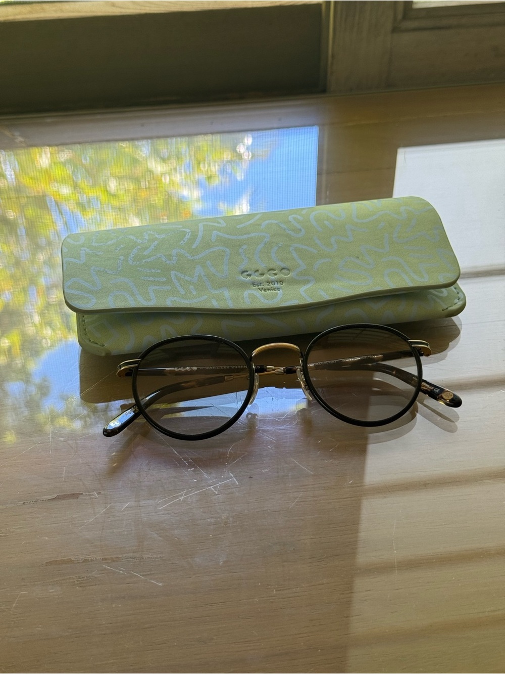 Garrett Leight Round Men's Sunglasses with Black Frames and Gold Bridge